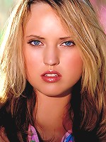 Kari Hilton plays outside with a garden hose