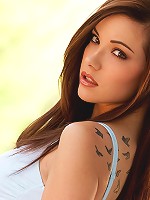 Elizabeth Marxs sits on a bench and takes off her top