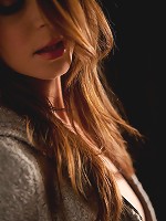 Amber Sym slides off her soft grey jacket