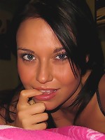 Ava Dawn takes some pictures on her bed.