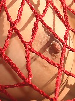 Teen wears red fishnet outdoors