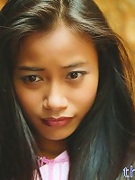 Really tiny Thai teen poses in cute outfit on the seaside rocks
