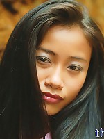 Really tiny Thai teen poses in cute outfit on the seaside rocks