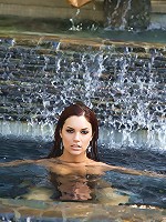 Jayden Cole is a vision as she dramatically emerges from beneath the pool's surface, sparkling water running down the length of her naked body and her wet red hair running in ringlets over her quivering breasts!
