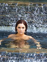 Jayden Cole is a vision as she dramatically emerges from beneath the pool's surface, sparkling water running down the length of her naked body and her wet red hair running in ringlets over her quivering breasts!