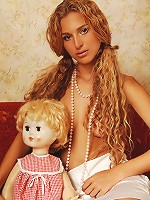 Zemani.com Kati - Young Kati with long hair and perfect breast in white dress and white socks plays with her doll and shows her fresh body at home.